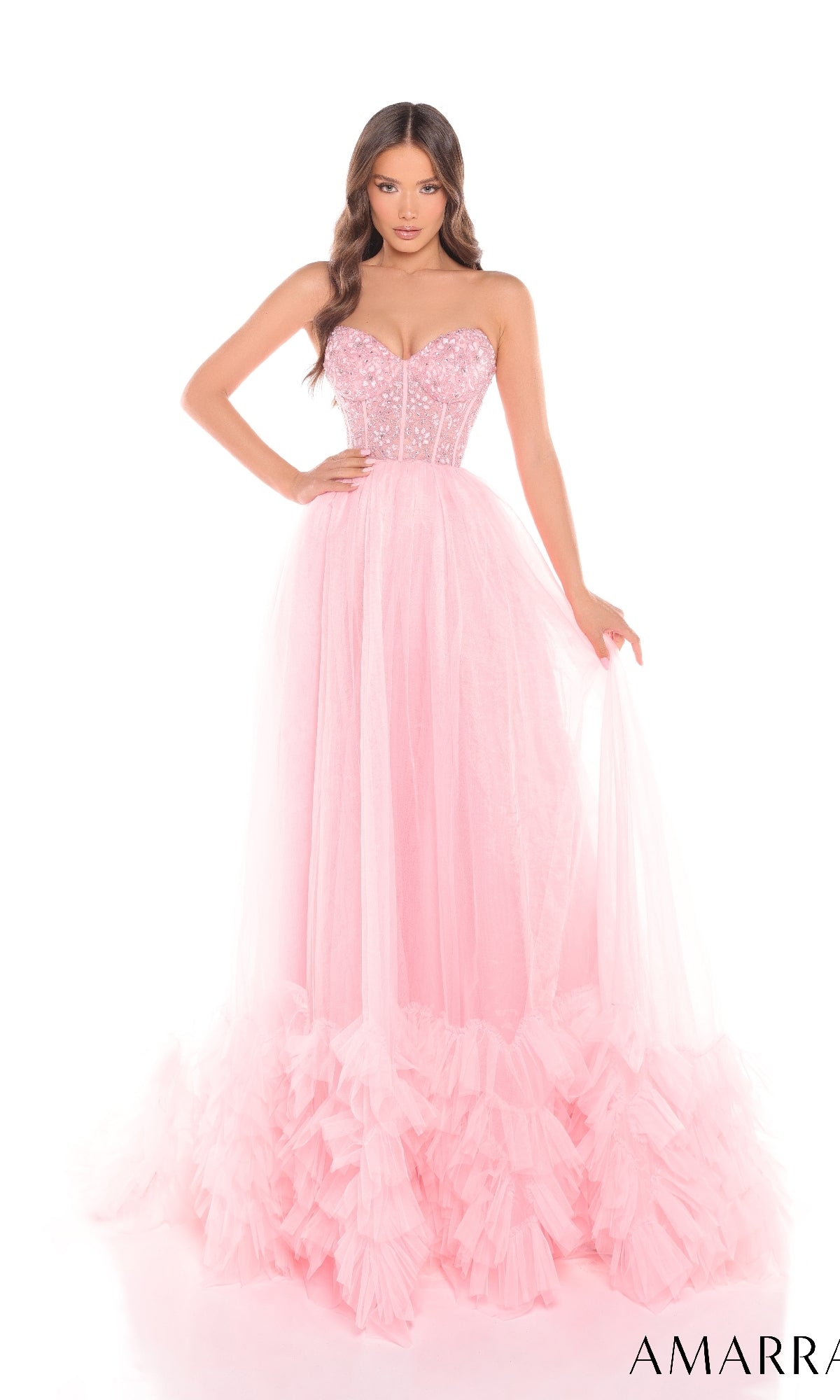 A woman models the Amarra 88339 long prom dress, featuring a strapless corset bodice, sheer tulle floor-length skirt, and ruffled hem, set against a white background.